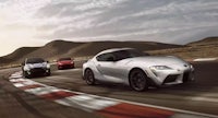 the 2020 toyota supra driving on a race track